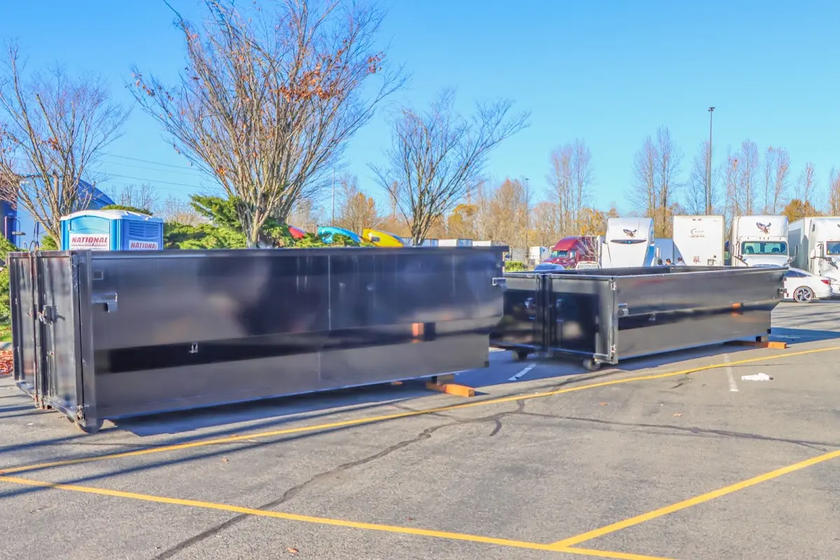 Professional dumpster rental service with roll-off container on residential driveway in Interlaken